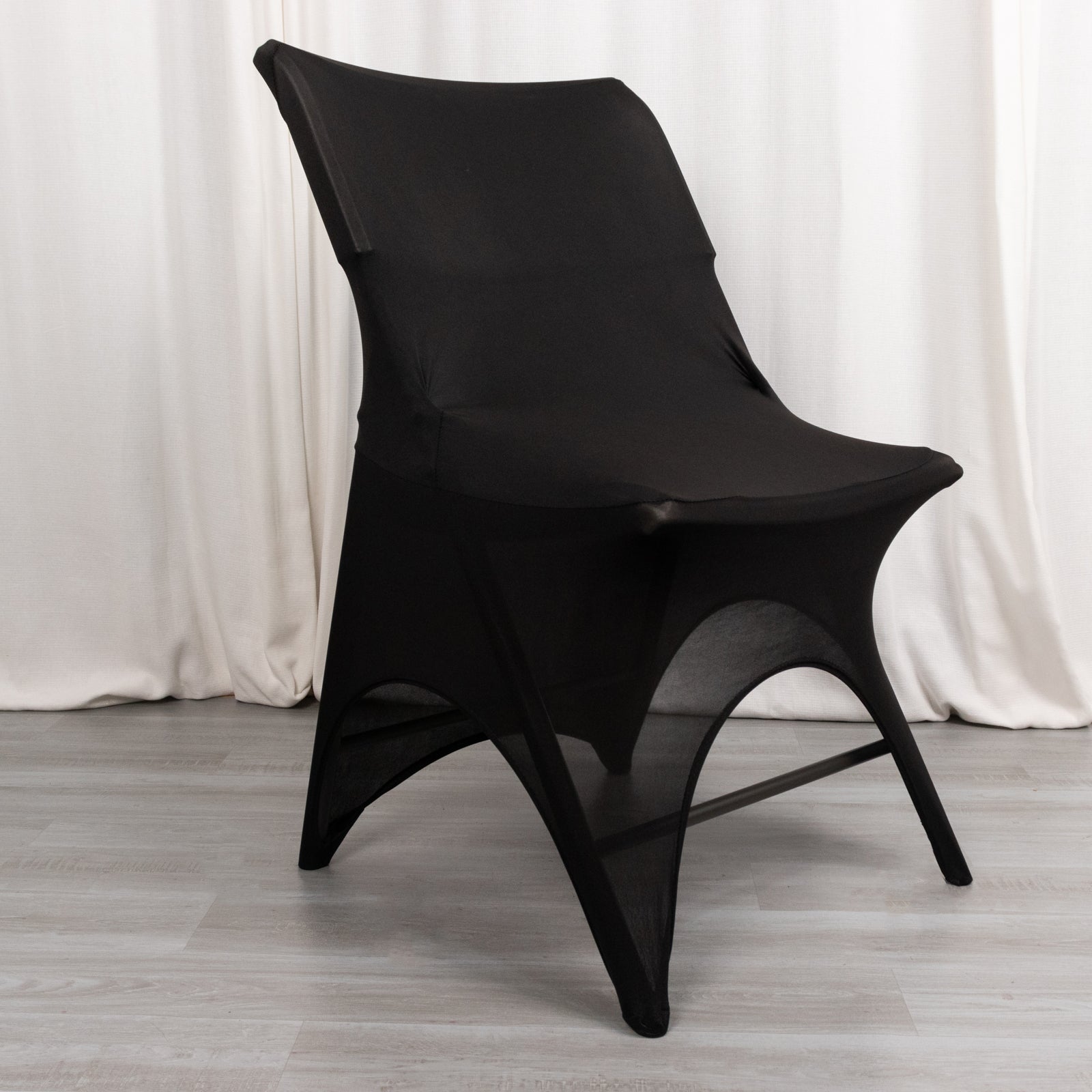 Black spandex wedding chair cover with foot pockets and open arch design.