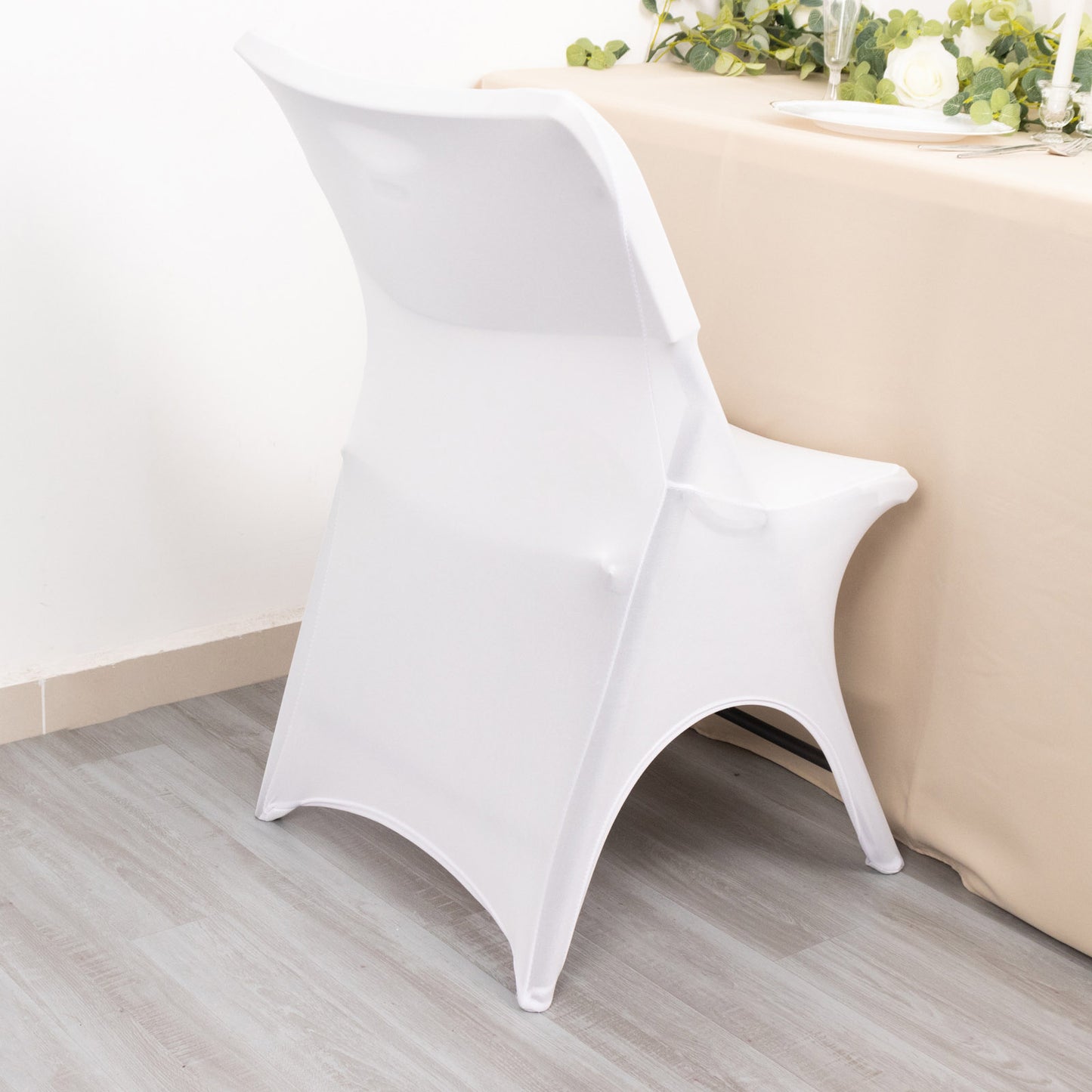 White fitted spandex wedding chair cover with foot pockets.