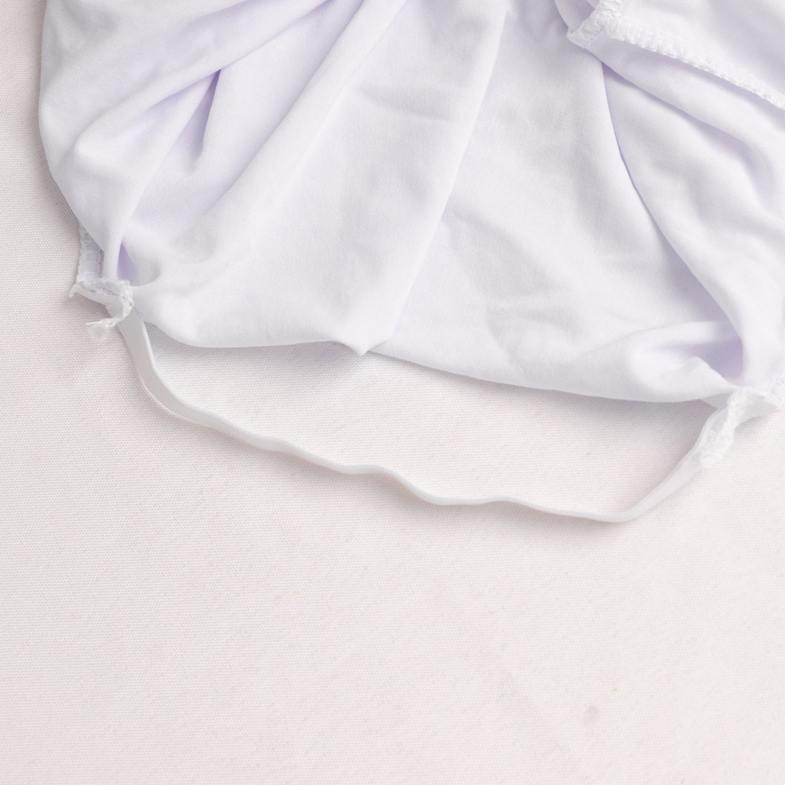 White spandex wedding chair cover with foot pockets and 3-way open arch.