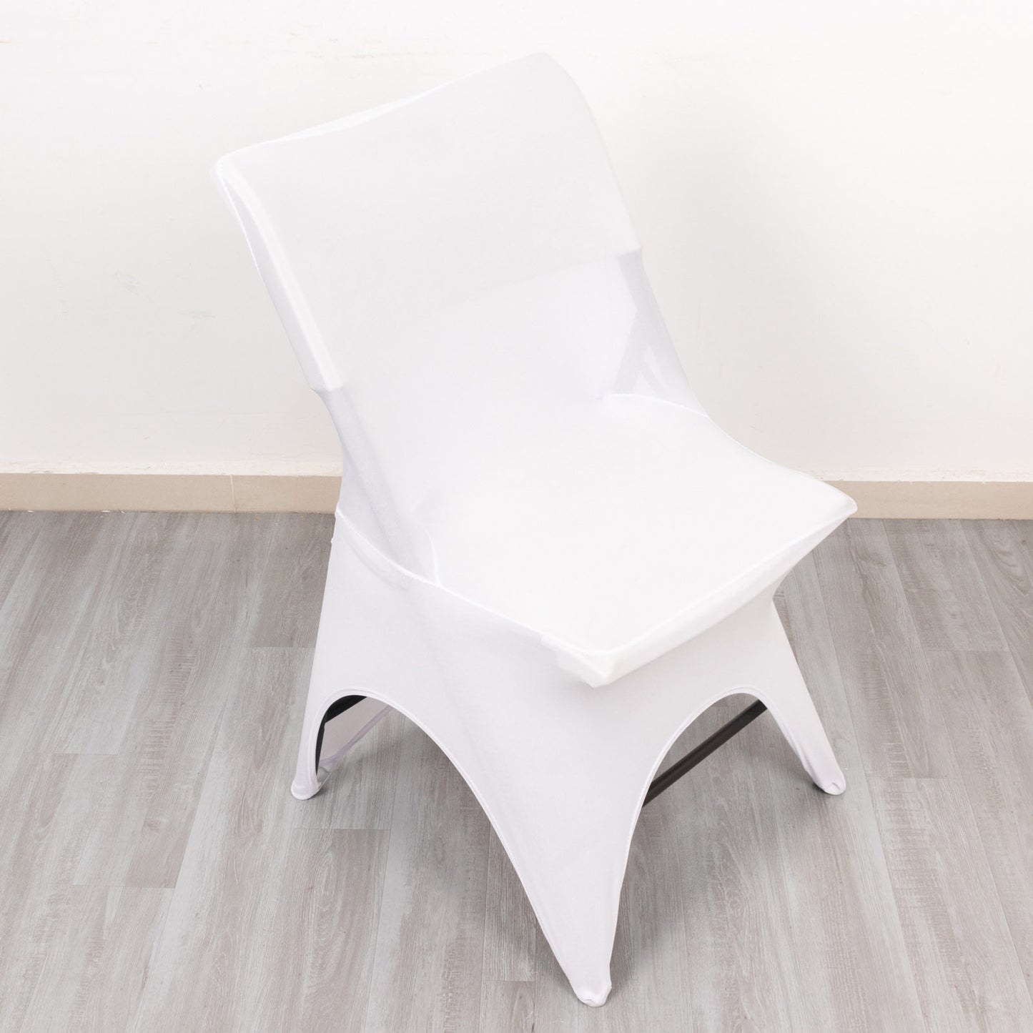 White premium spandex wedding chair cover with open arch design.