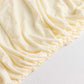 Ivory fitted spandex banquet chair cover with gathered edges.