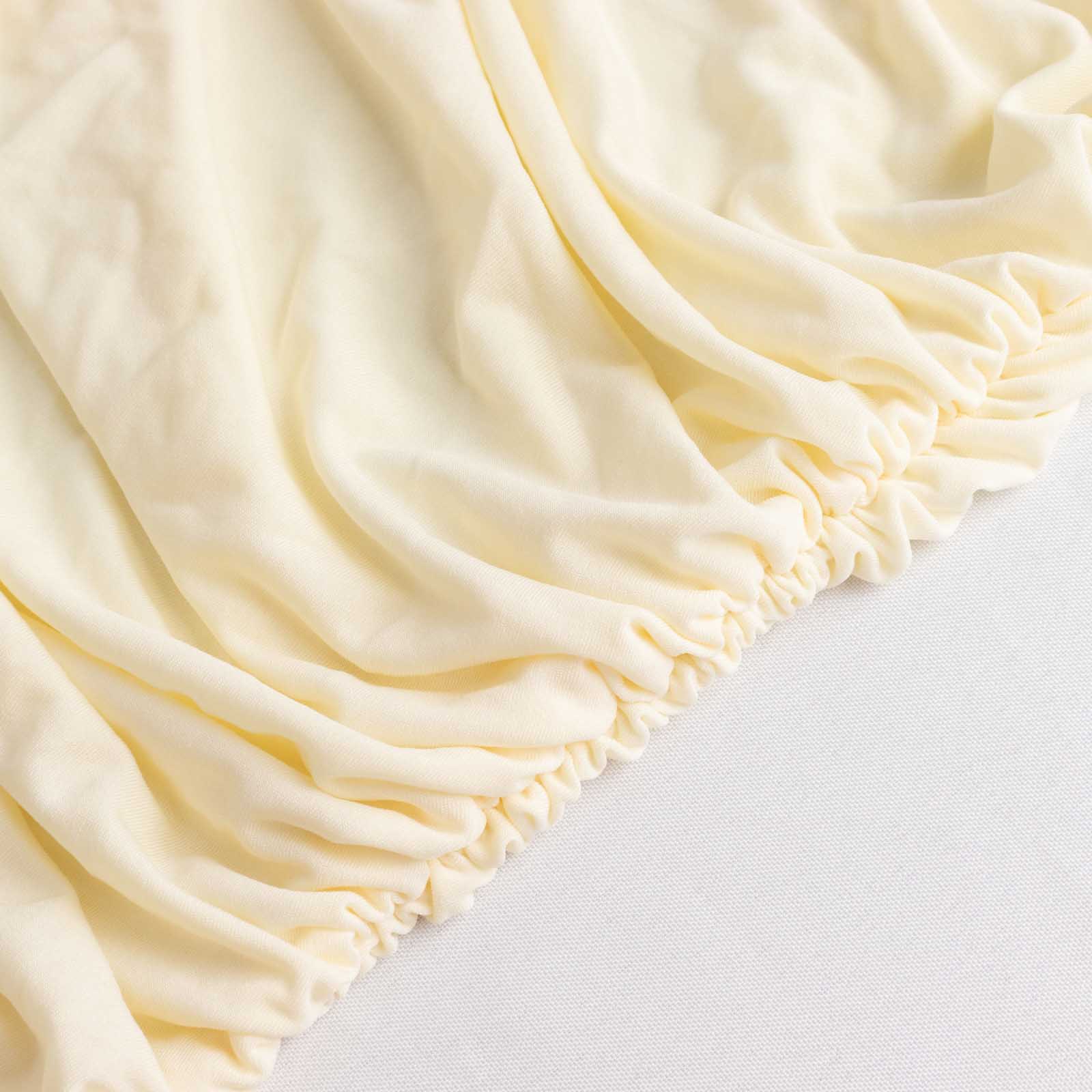 Ivory fitted spandex banquet chair cover with gathered edges.