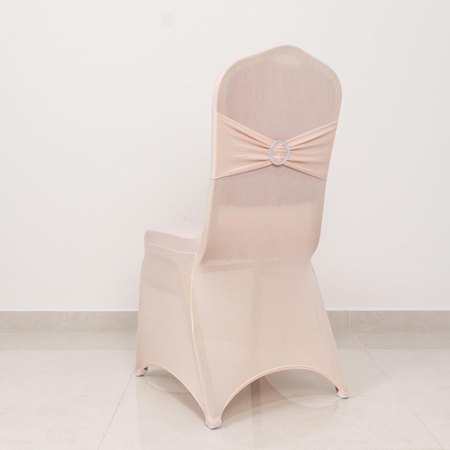 Blush spandex banquet chair cover with silver rhinestone sash.
