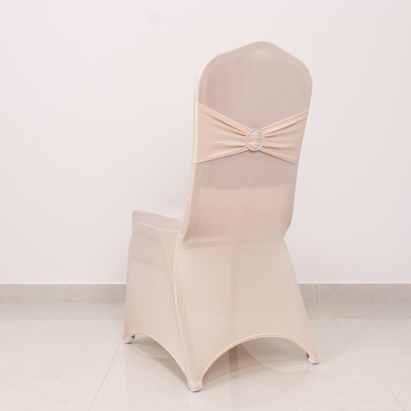 Blush spandex banquet chair cover with silver rhinestone sash.