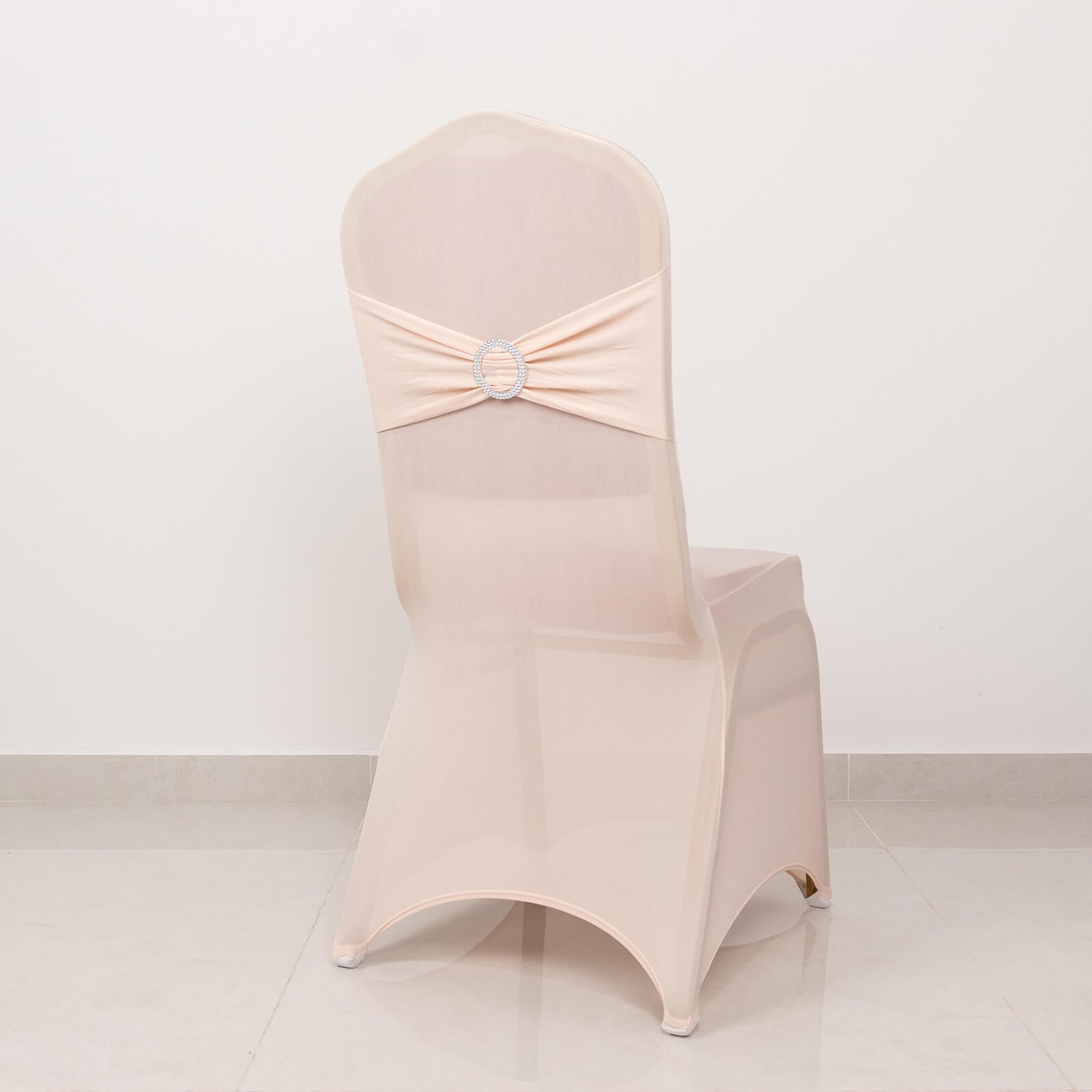 Blush spandex banquet chair cover with silver rhinestone sash.