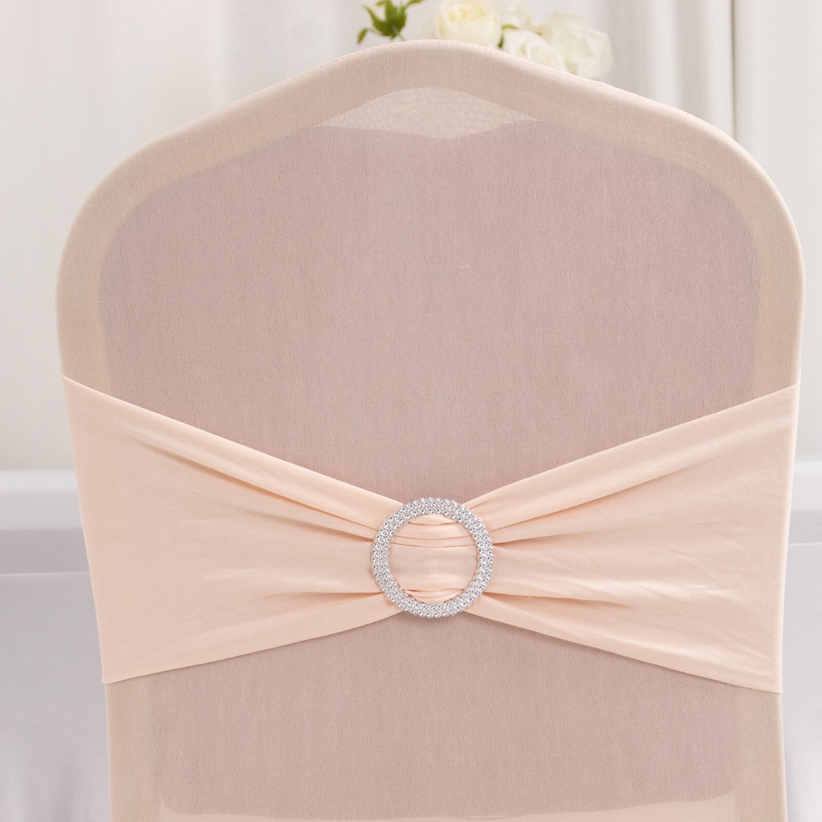 Blush spandex banquet chair cover with silver rhinestone sash.