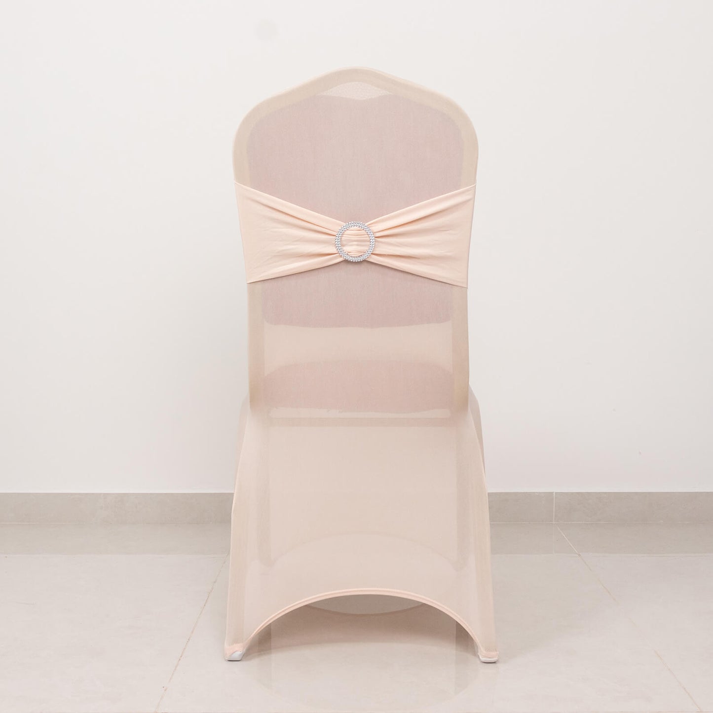 Blush spandex banquet chair cover with silver rhinestone sash band.