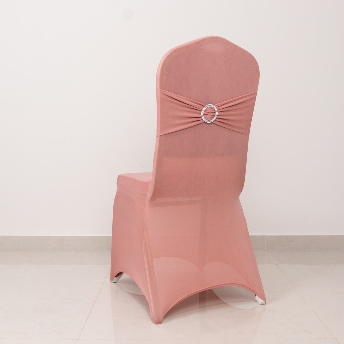 Dusty rose spandex banquet chair cover with silver rhinestone sash.