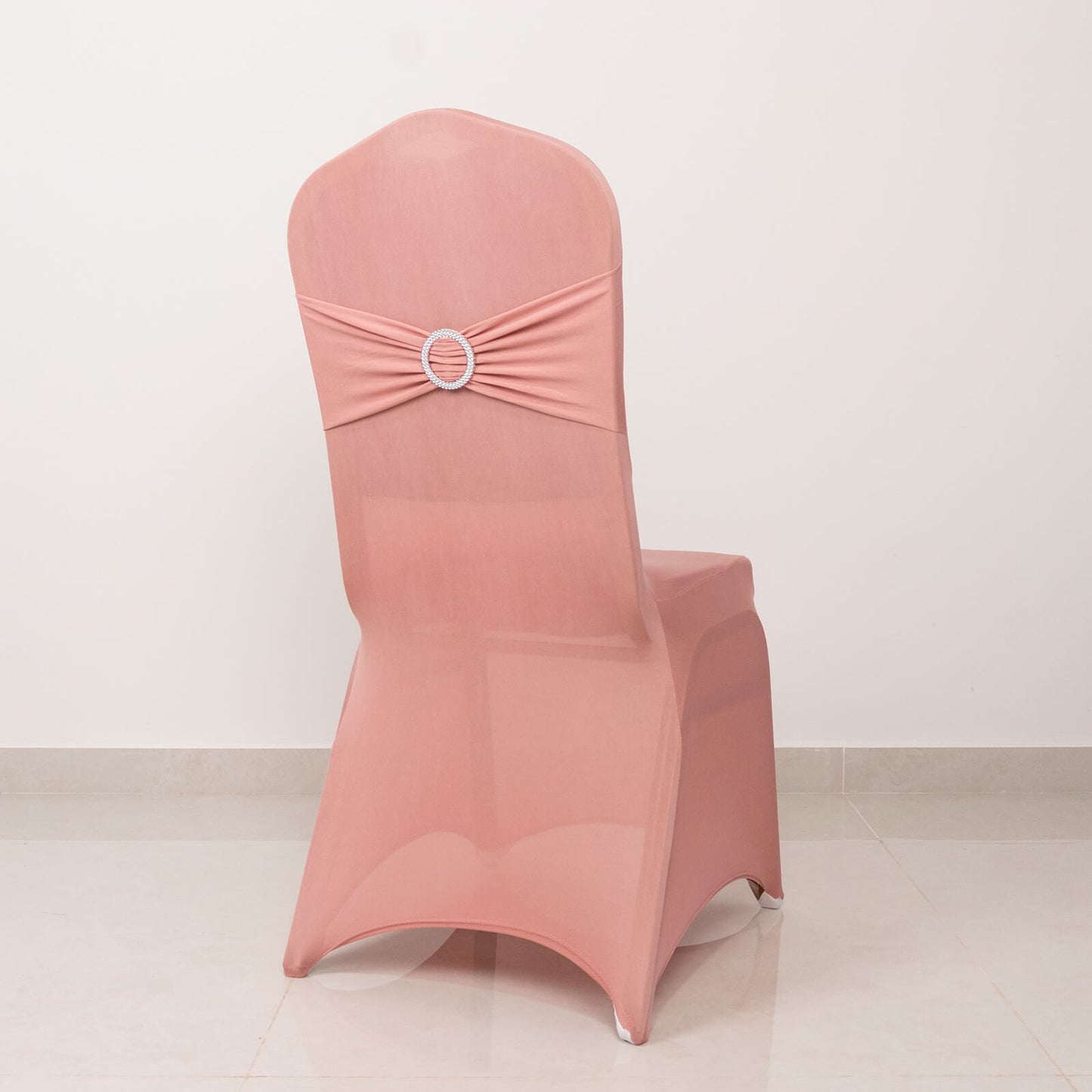 Dusty rose spandex banquet chair cover with silver rhinestone buckle.