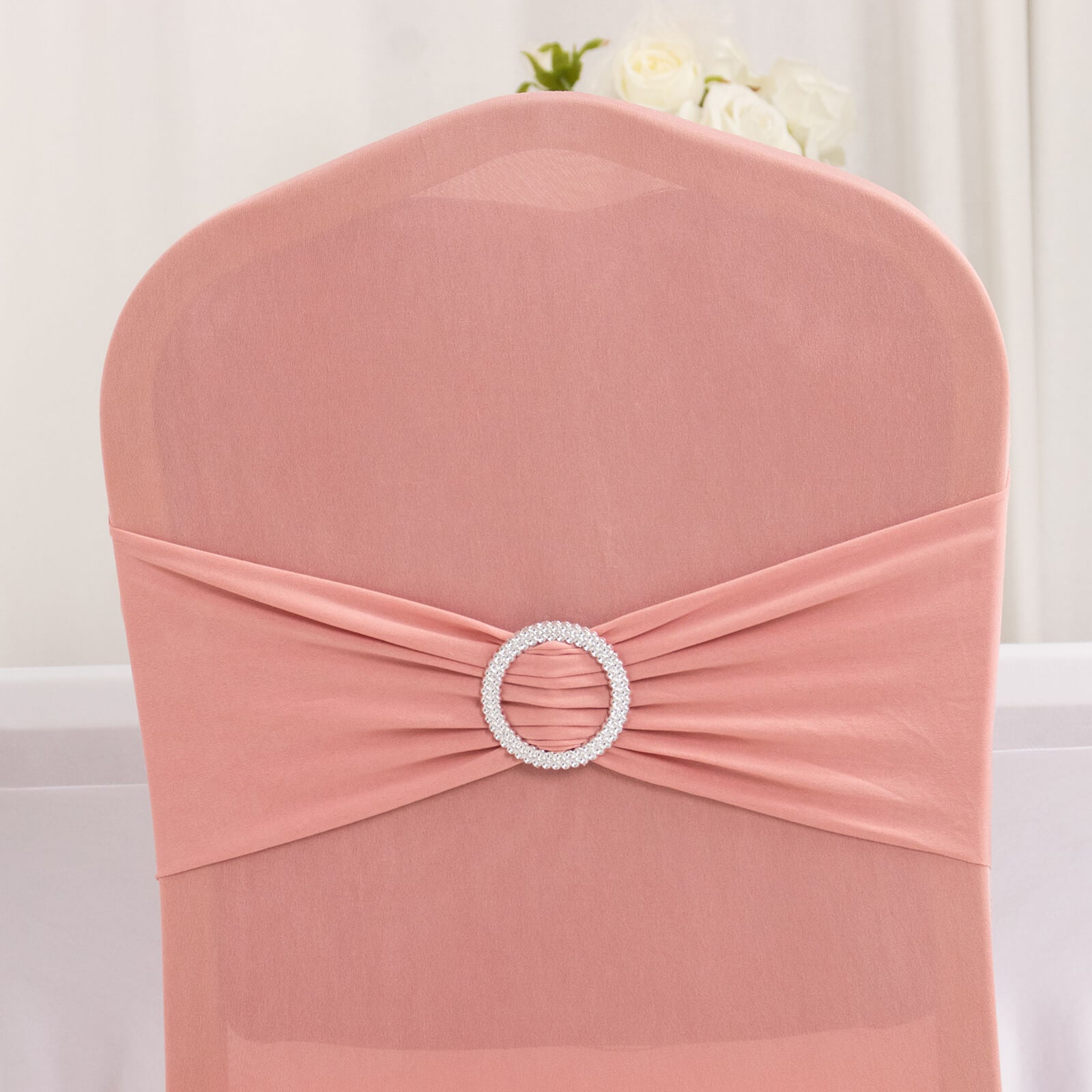 Dusty rose banquet chair cover with silver rhinestone sash.