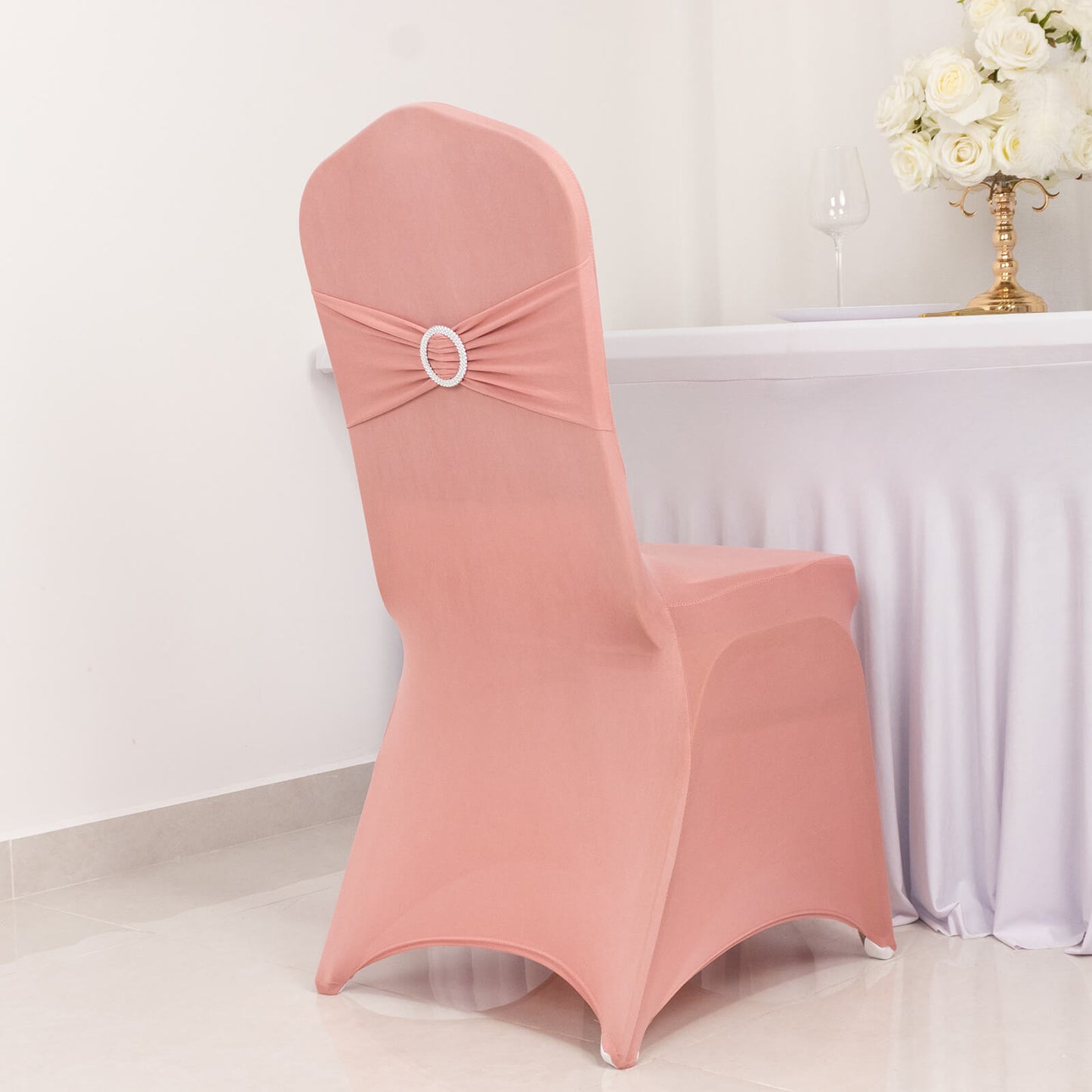 Dusty rose spandex banquet chair cover with rhinestone sash.