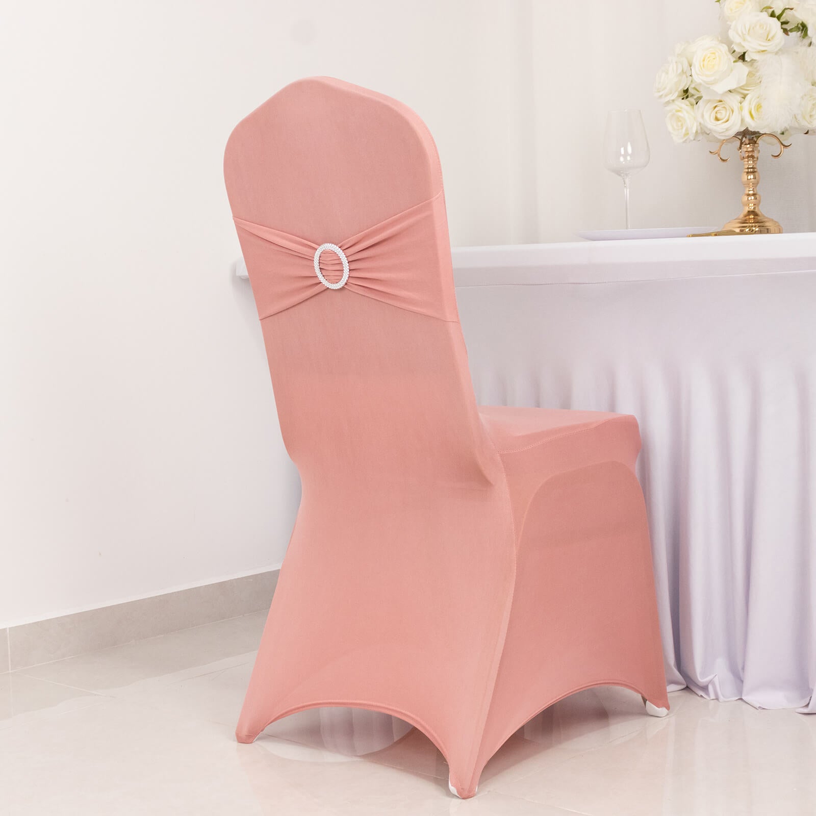 Dusty rose spandex banquet chair cover with rhinestone sash.