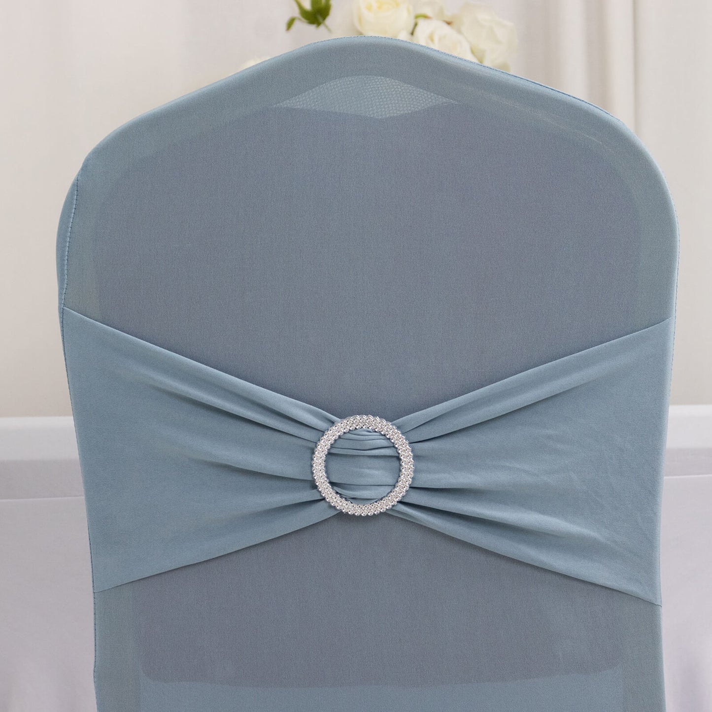 Dusty blue spandex banquet chair cover with silver rhinestone sash.