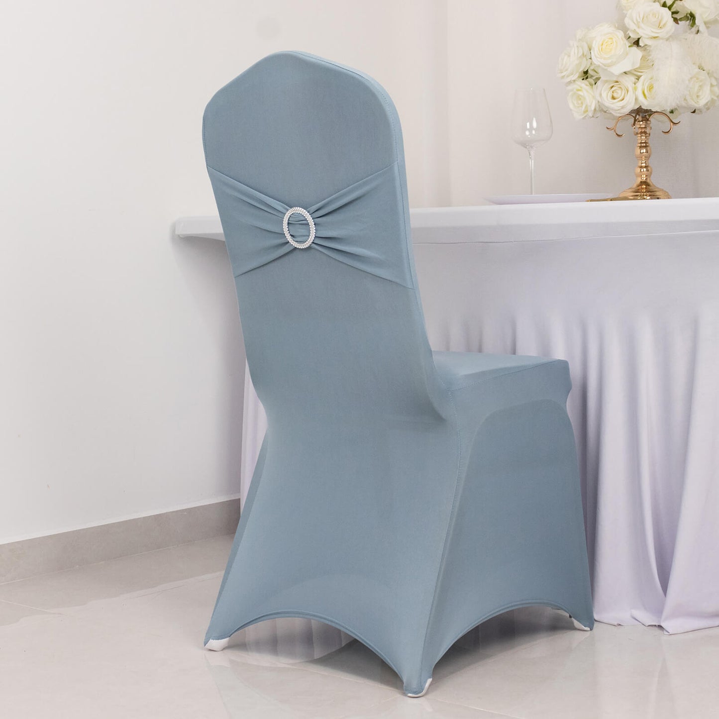 Dusty blue spandex banquet chair cover with silver rhinestone sash.