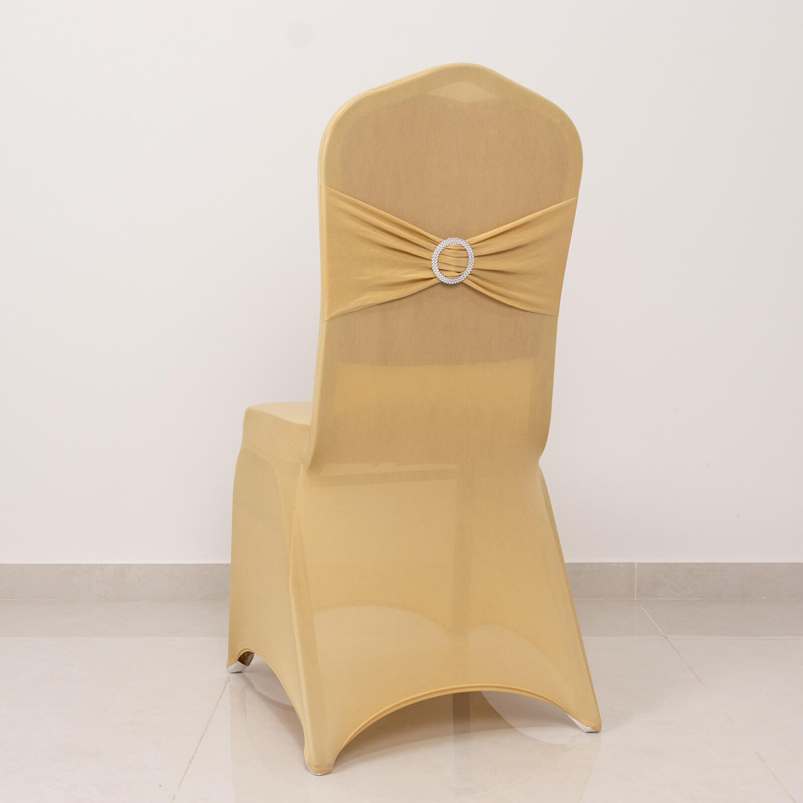 Champagne spandex banquet chair cover with silver rhinestone sash.