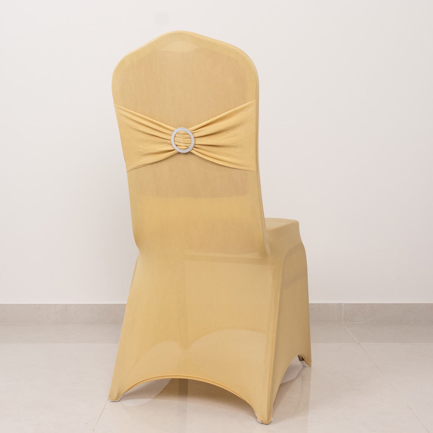 Champagne spandex banquet chair cover with silver rhinestone sash.