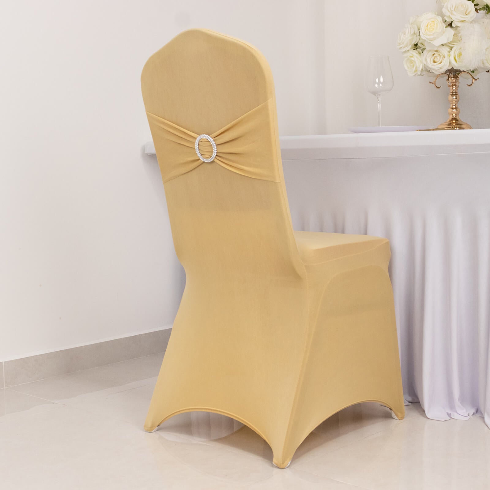 Champagne spandex banquet chair cover with silver rhinestone sash.