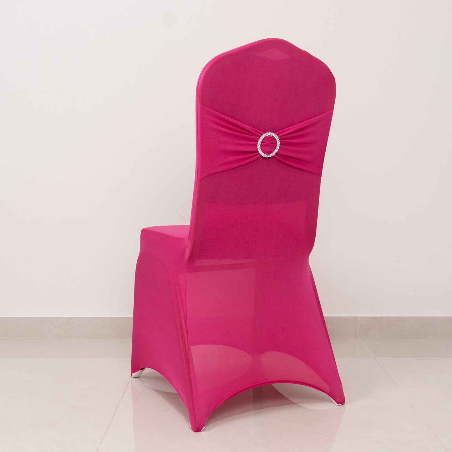 Fuchsia spandex banquet chair cover with silver rhinestone sash.