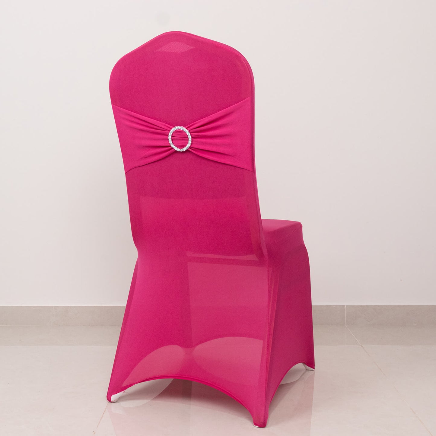 Fuchsia spandex banquet chair cover with silver rhinestone buckle.
