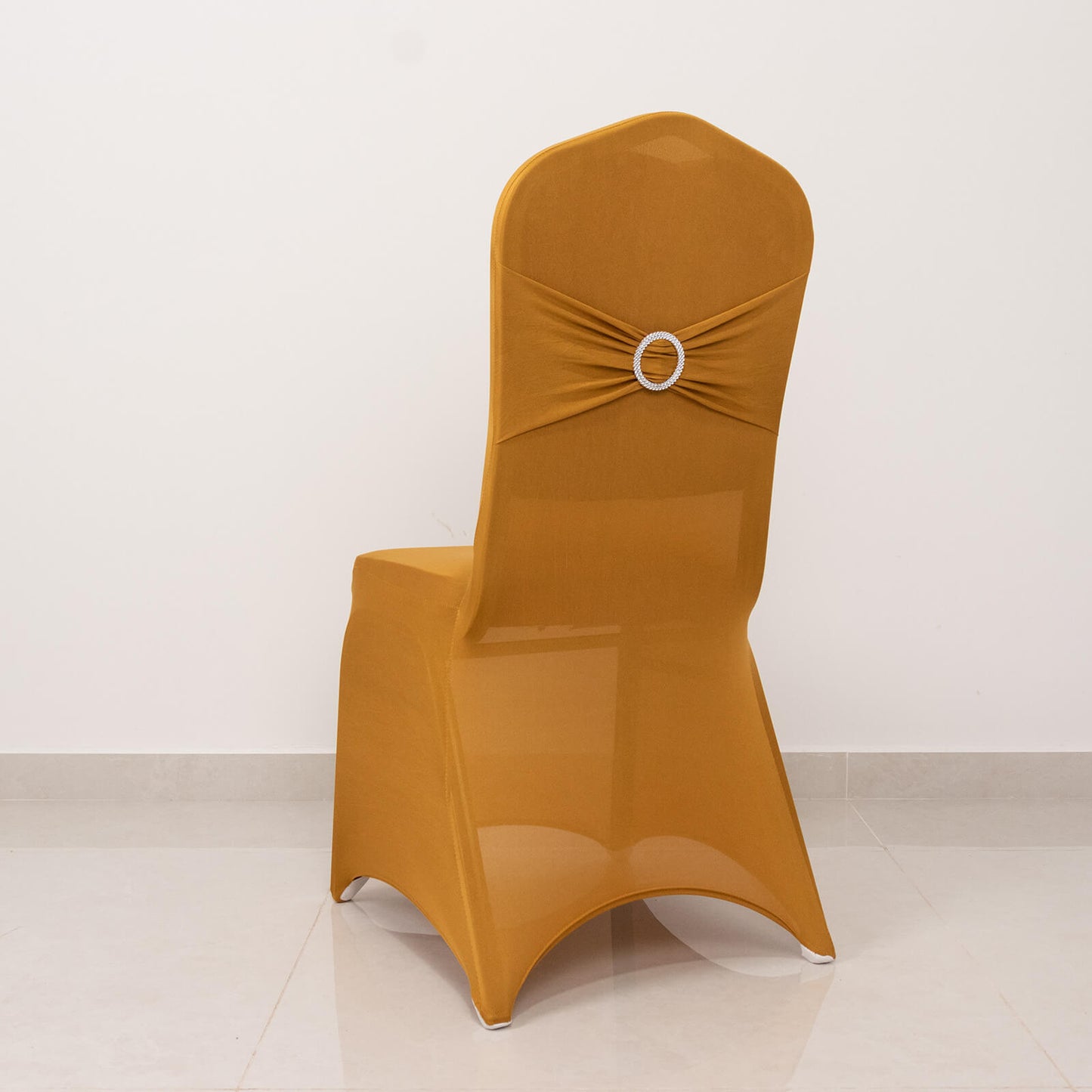 Gold banquet chair cover with silver rhinestone sash band.