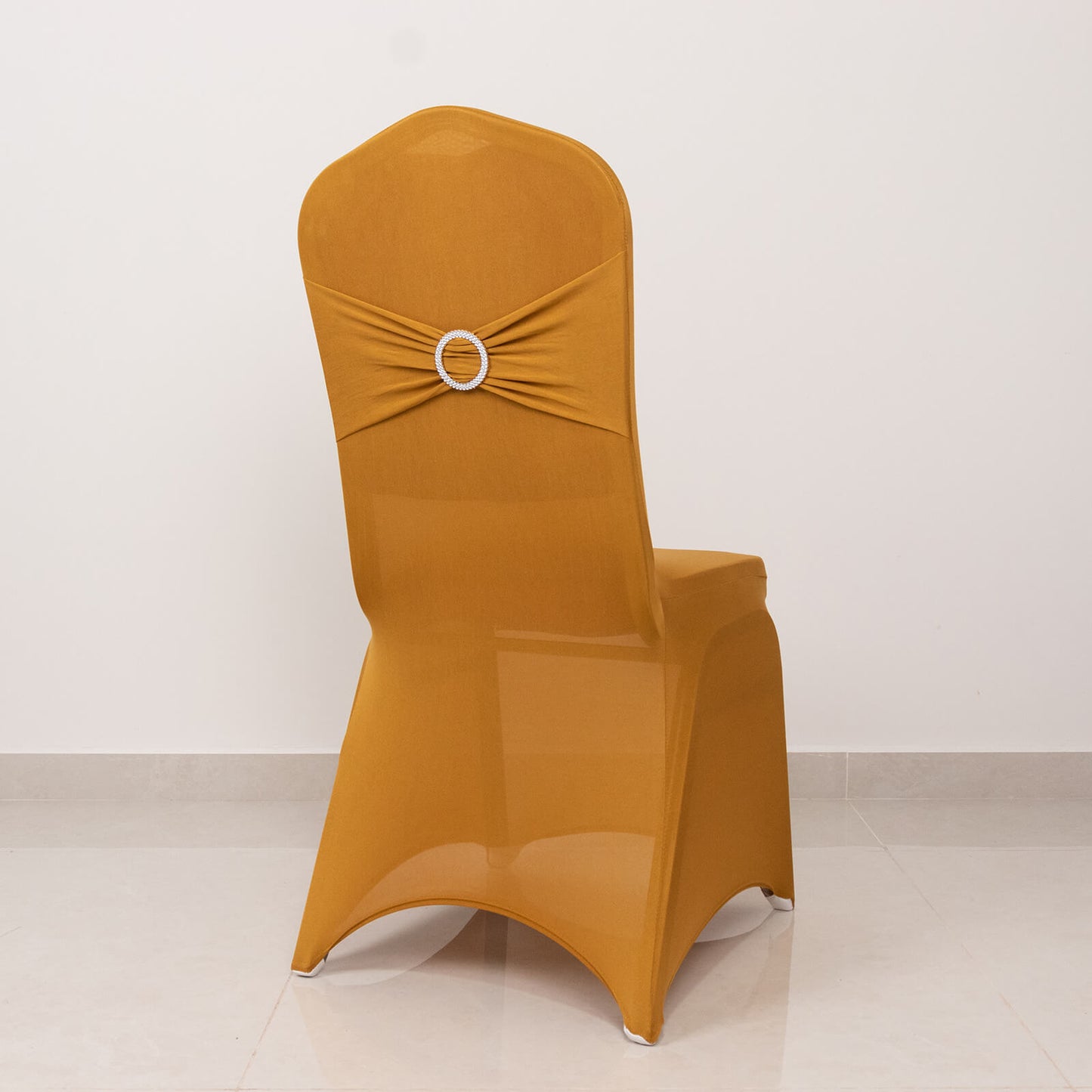 Gold spandex chair cover with silver rhinestone buckle detail.
