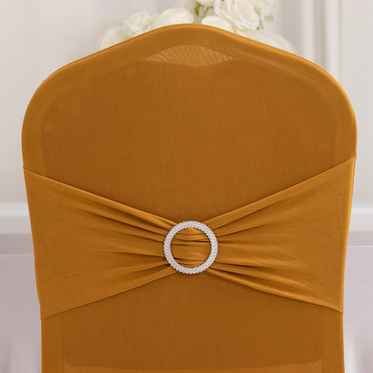 Gold spandex banquet chair cover with silver rhinestone sash.