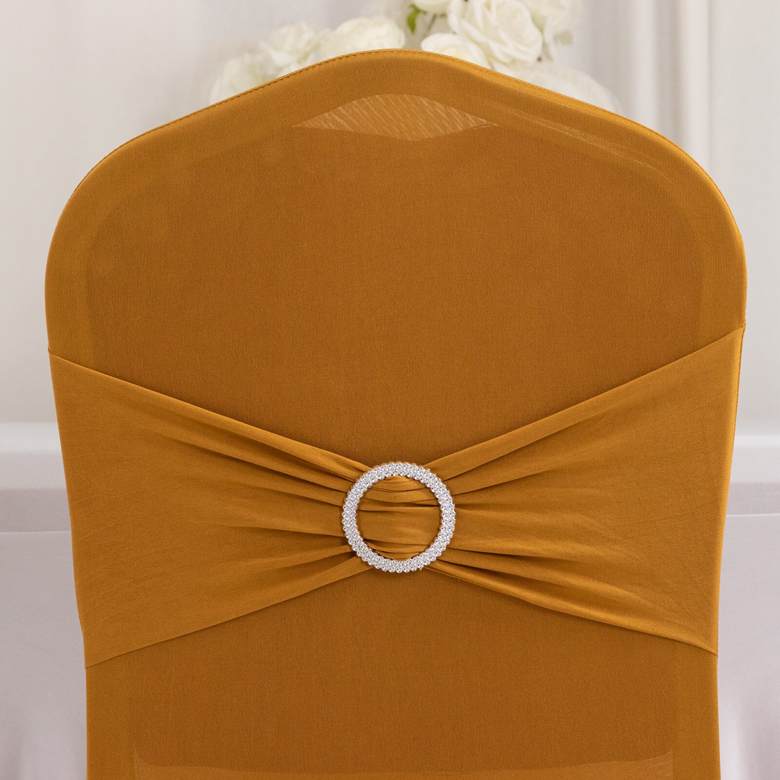 Gold spandex banquet chair cover with silver rhinestone sash.