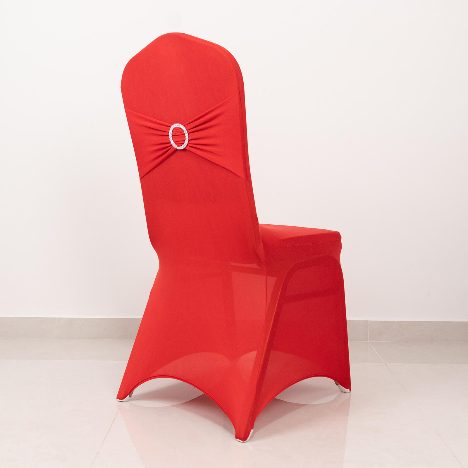 Red spandex banquet chair cover with silver rhinestone buckle sash.