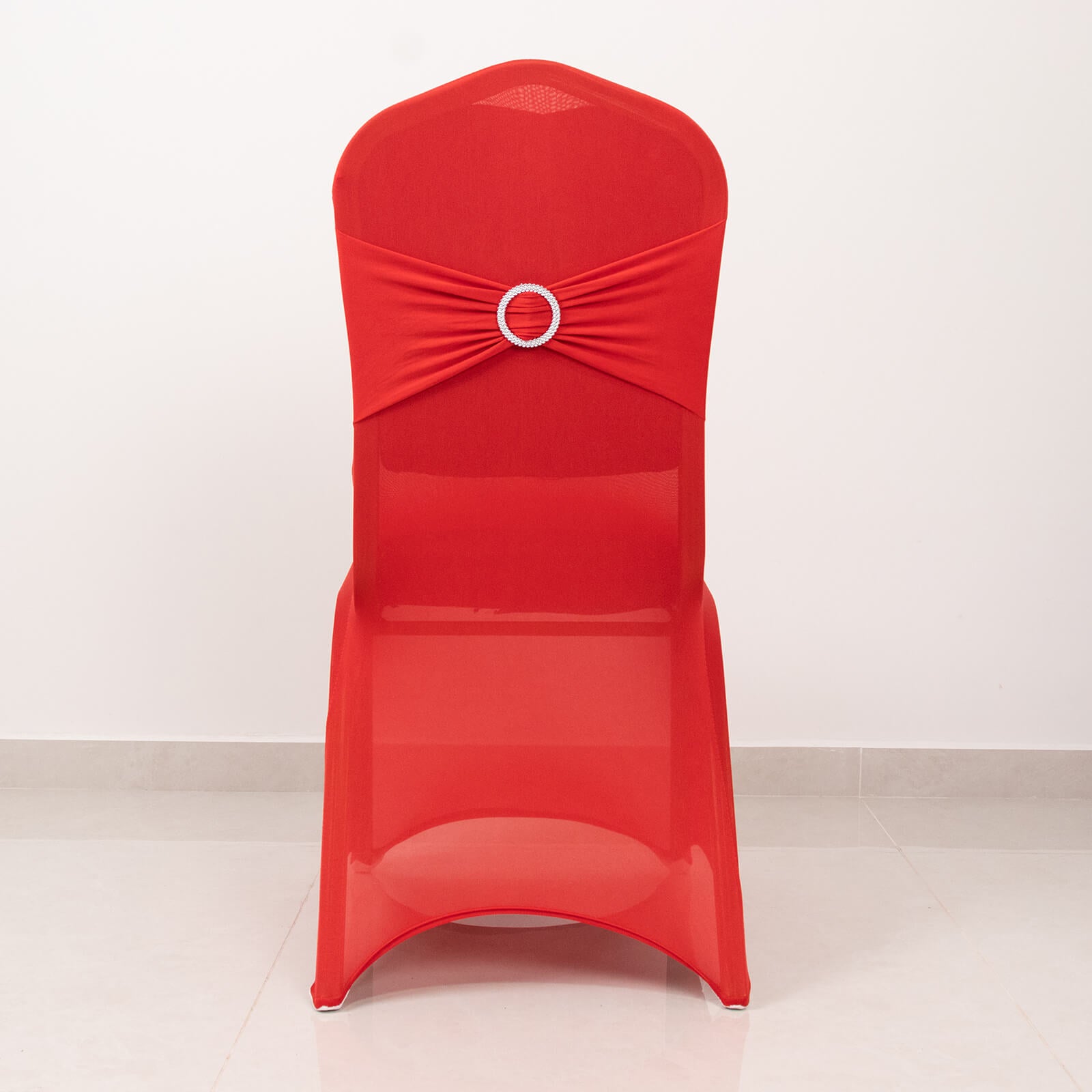 Red spandex banquet chair cover with silver rhinestone sash.