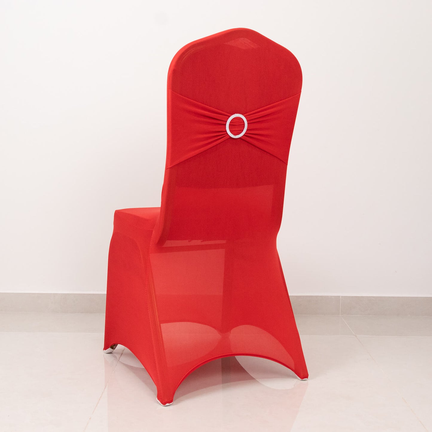Red spandex banquet chair cover with silver rhinestone sash.