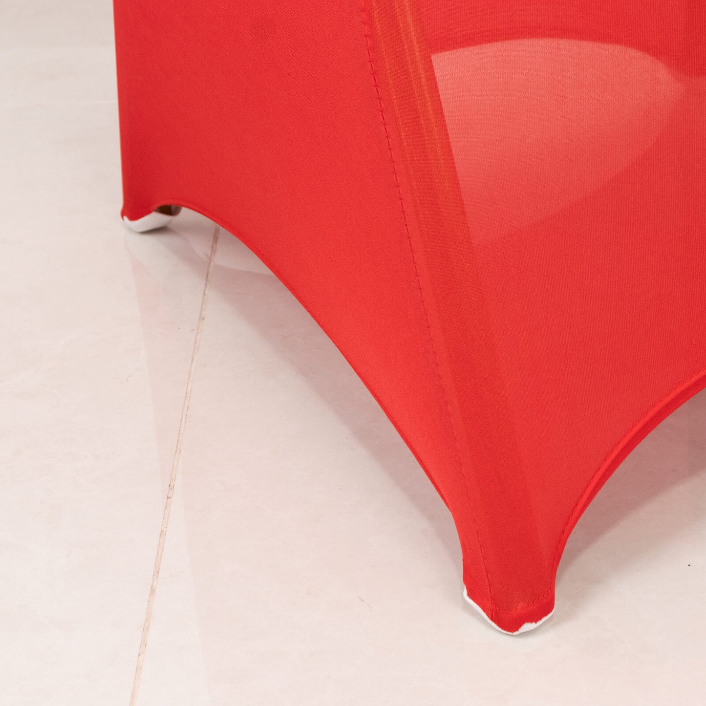 Red spandex banquet chair cover with silver rhinestone sash.