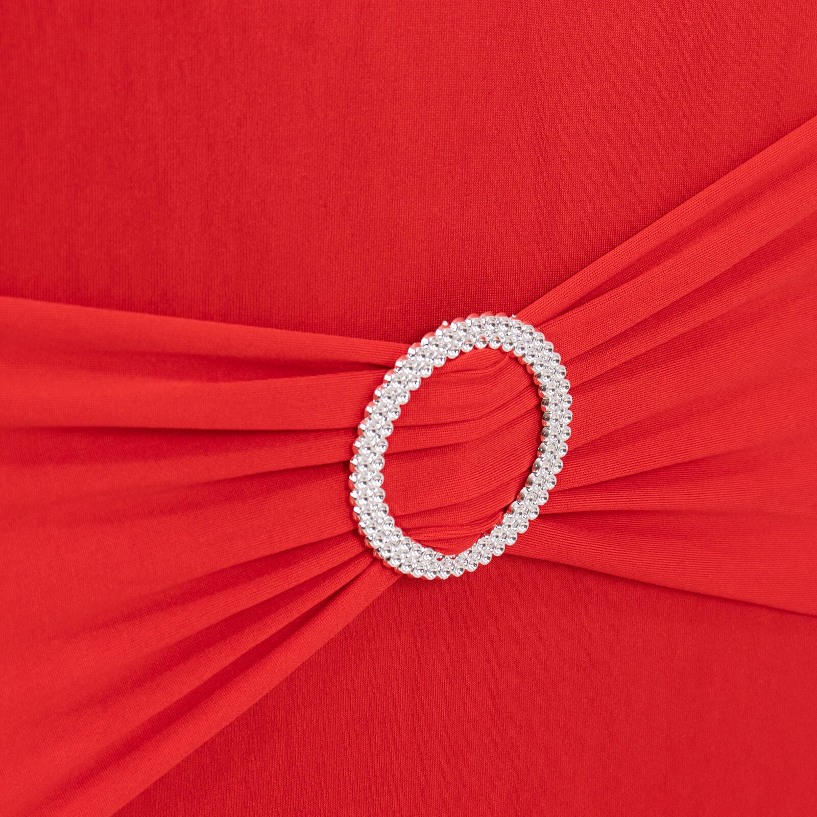 Red spandex banquet chair cover with silver rhinestone buckle.