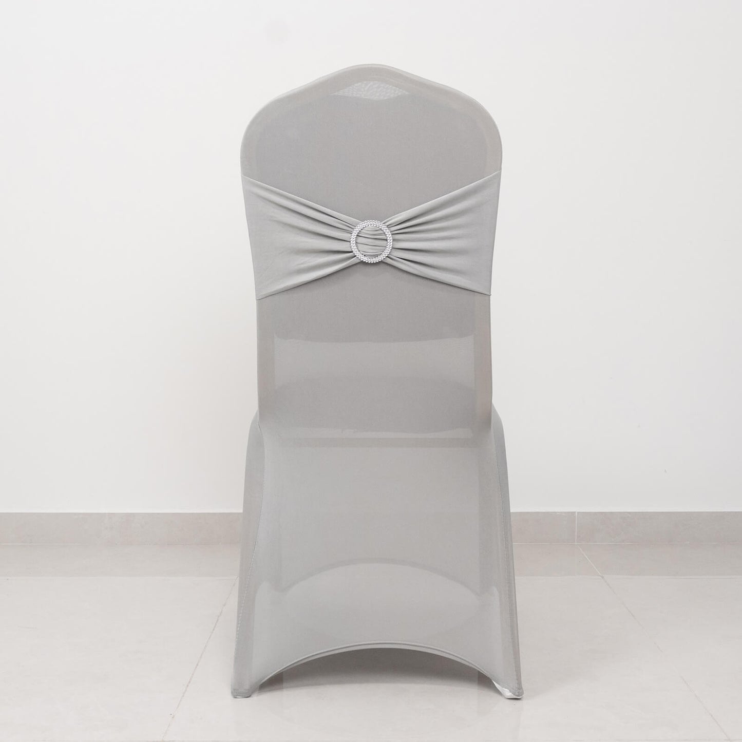 Silver spandex banquet chair cover with rhinestone sash band.