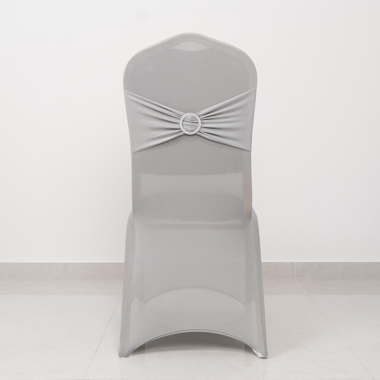 Silver spandex banquet chair cover with rhinestone sash band.