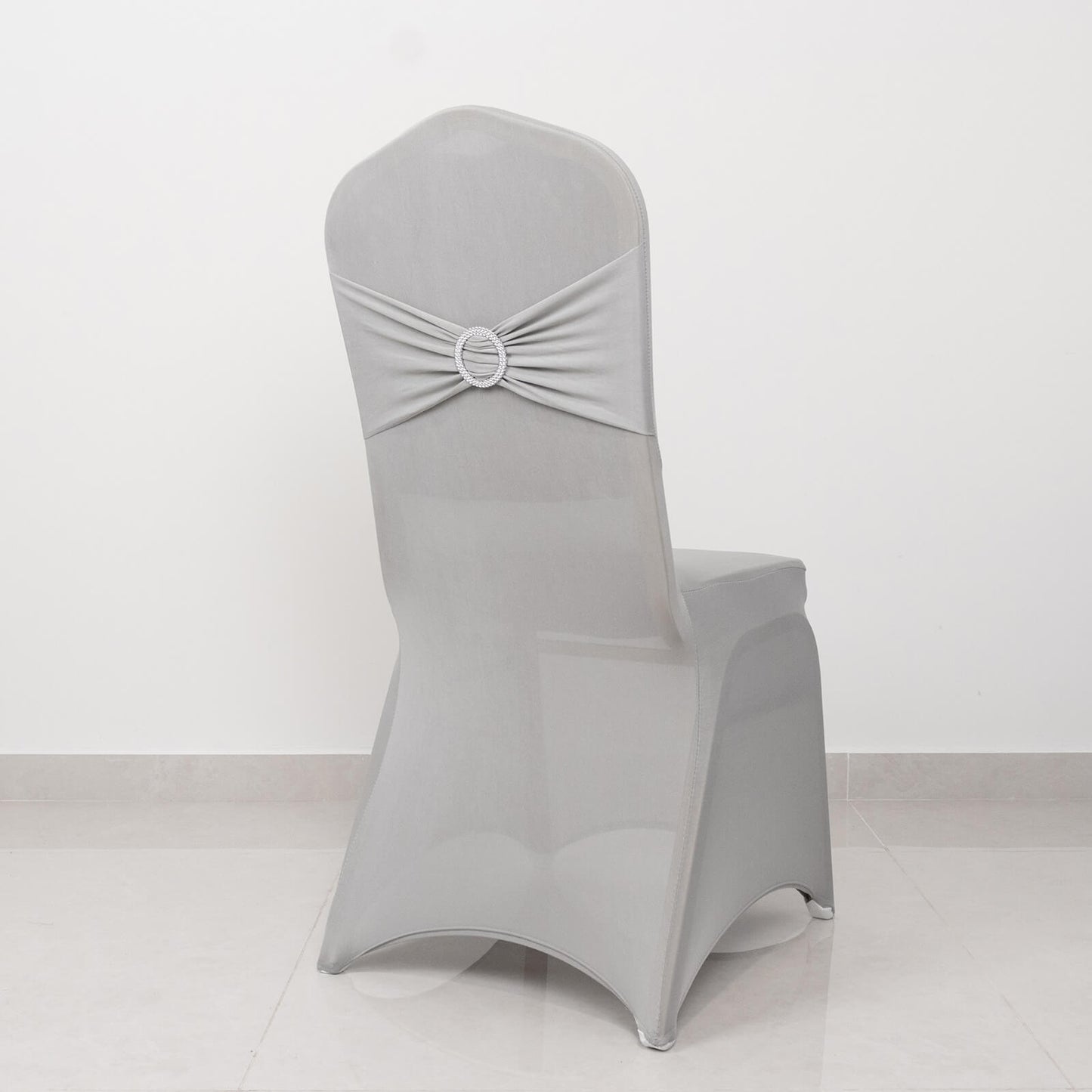 Silver spandex banquet chair cover with rhinestone sash.