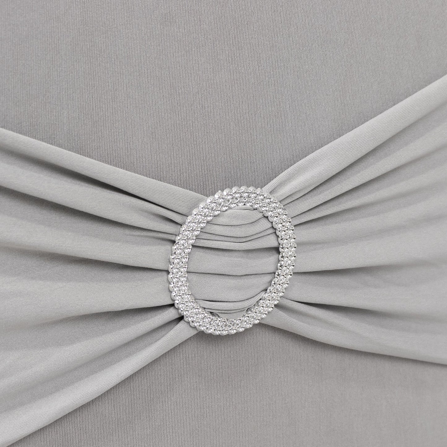 Silver spandex banquet chair cover with rhinestone buckle detail.