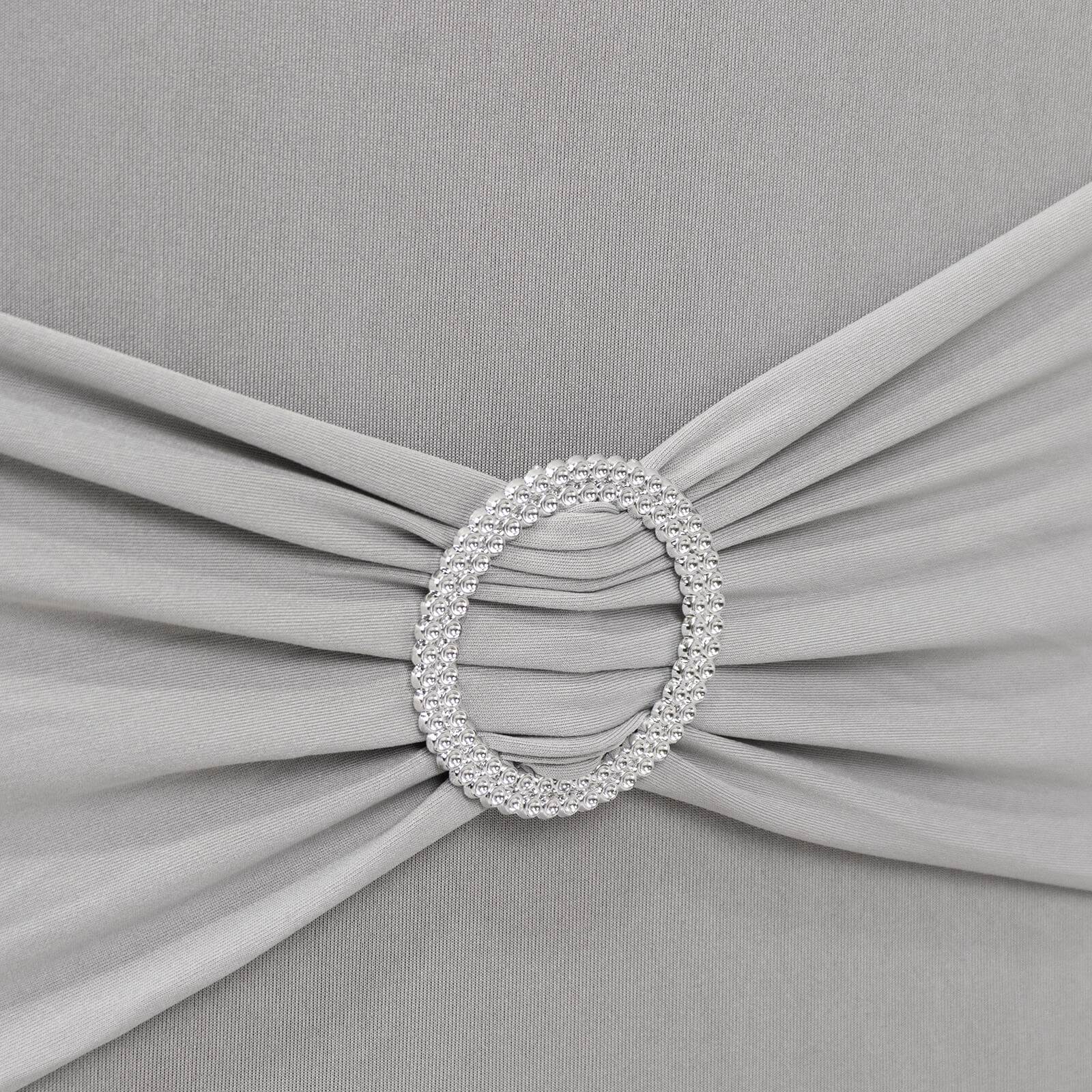 Silver spandex banquet chair cover with rhinestone buckle detail.