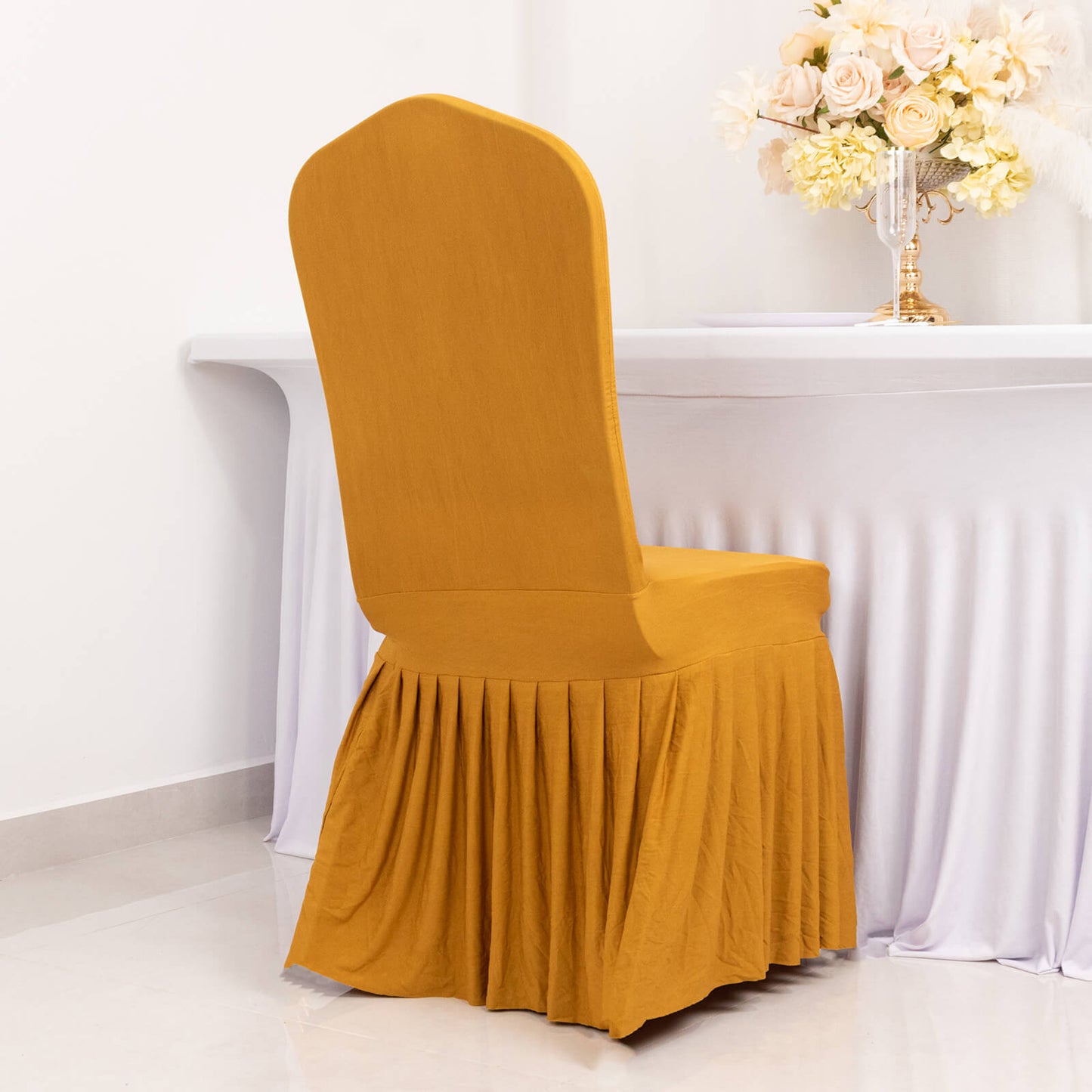 Gold ruffle pleated chair slipcover for banquet settings.
