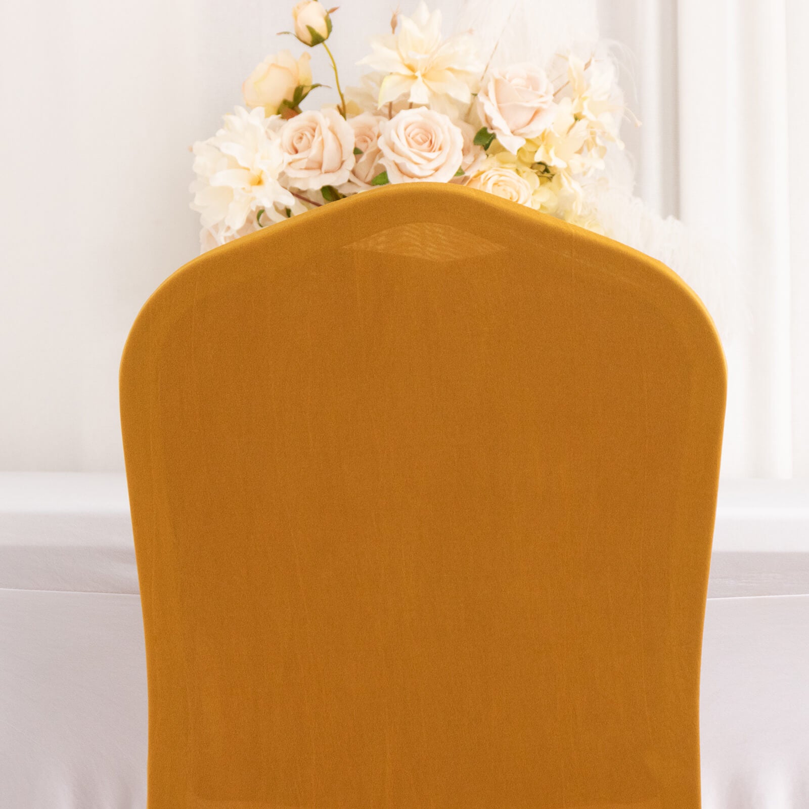 Gold fitted chair cover with ruffle pleats, perfect for banquet settings.