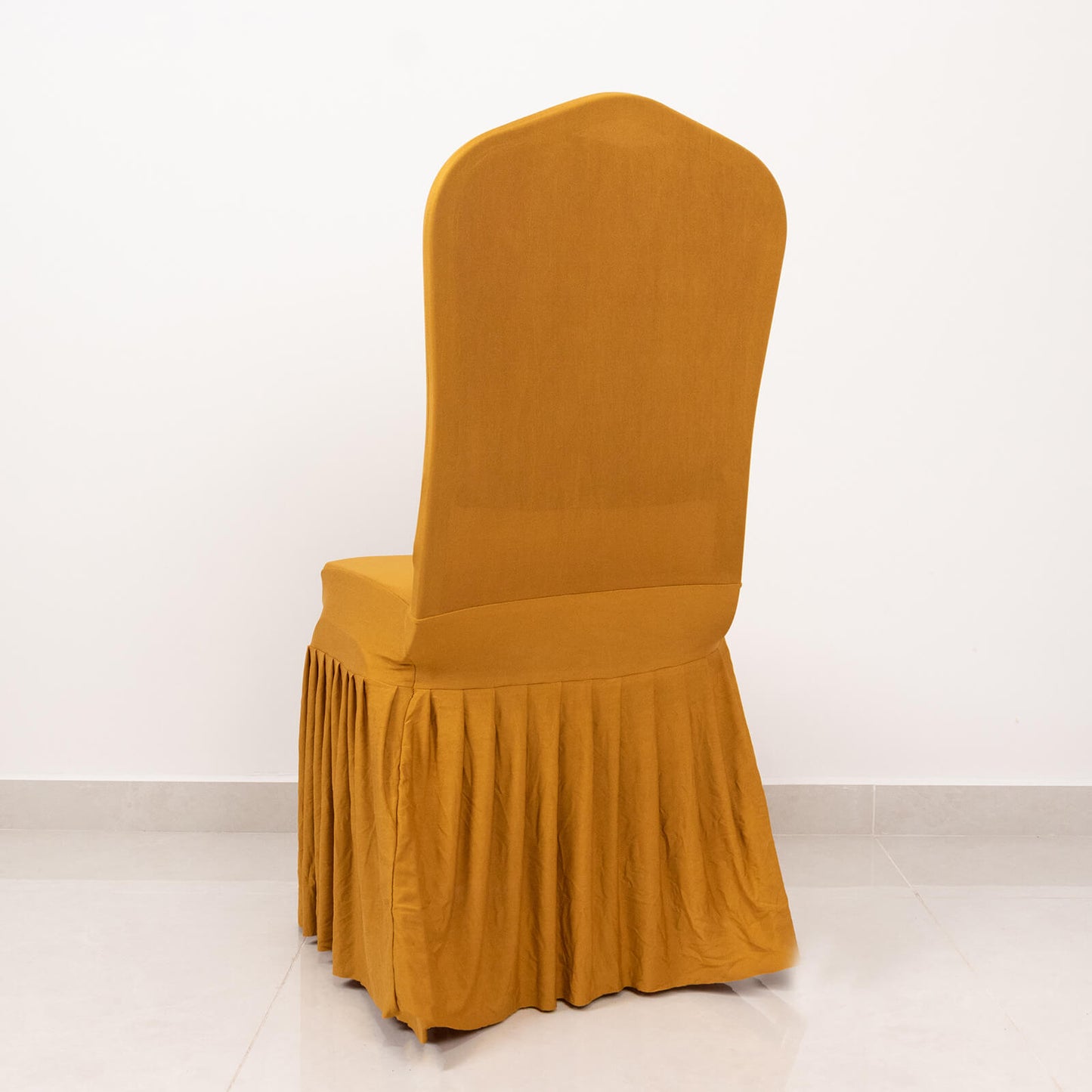 Gold pleated spandex chair cover for banquet events.