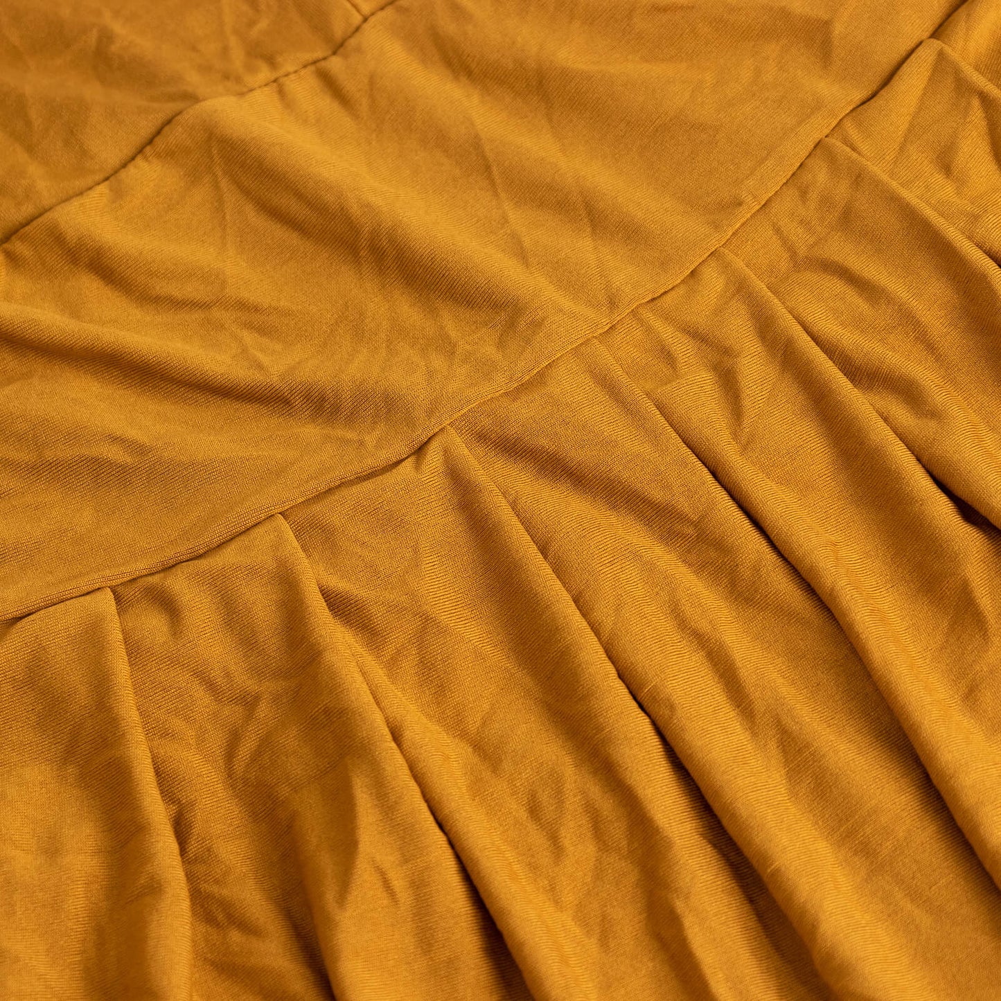 Gold ruffle pleated skirt banquet chair slipcover in a warm golden hue.