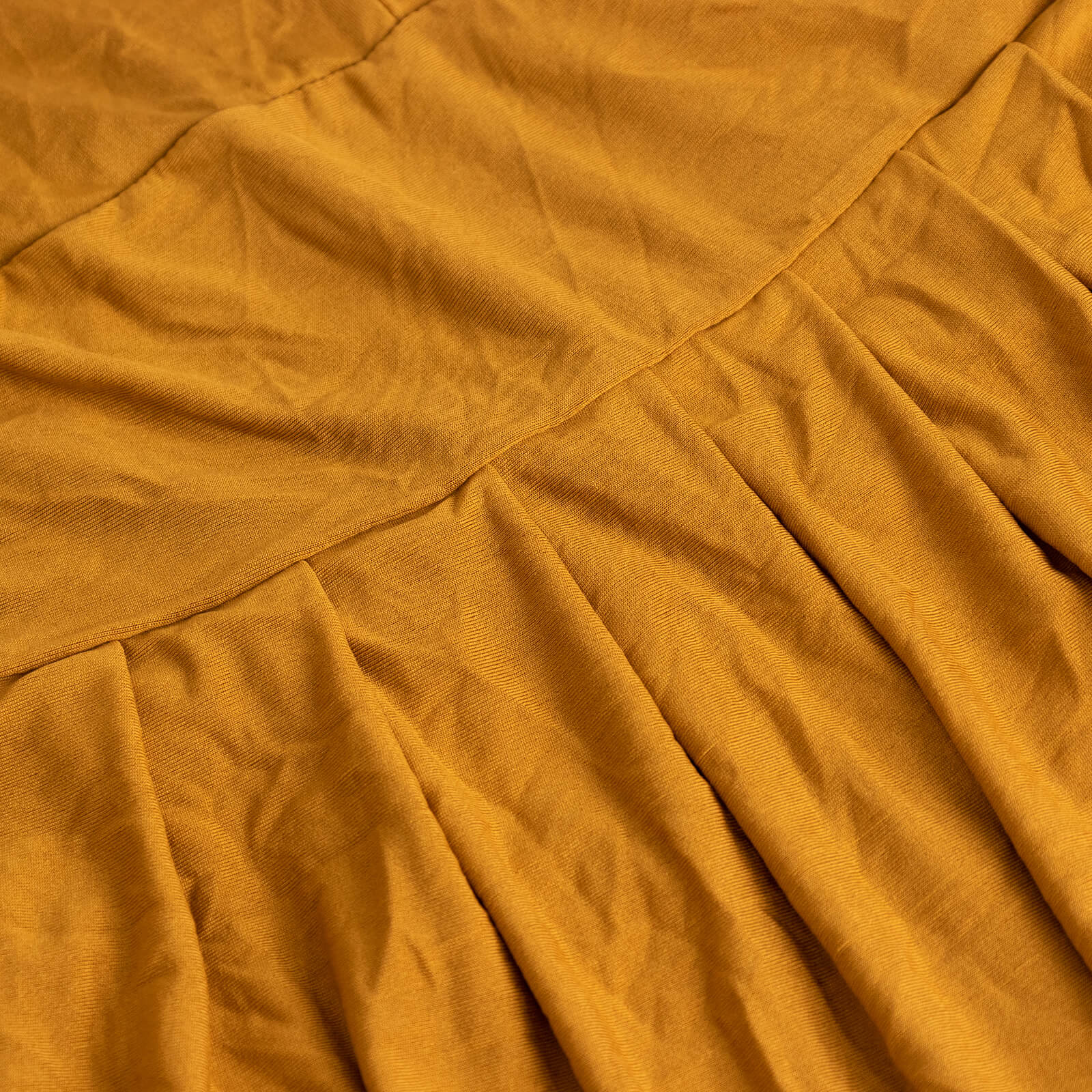 Gold ruffle pleated skirt banquet chair slipcover in a warm golden hue.