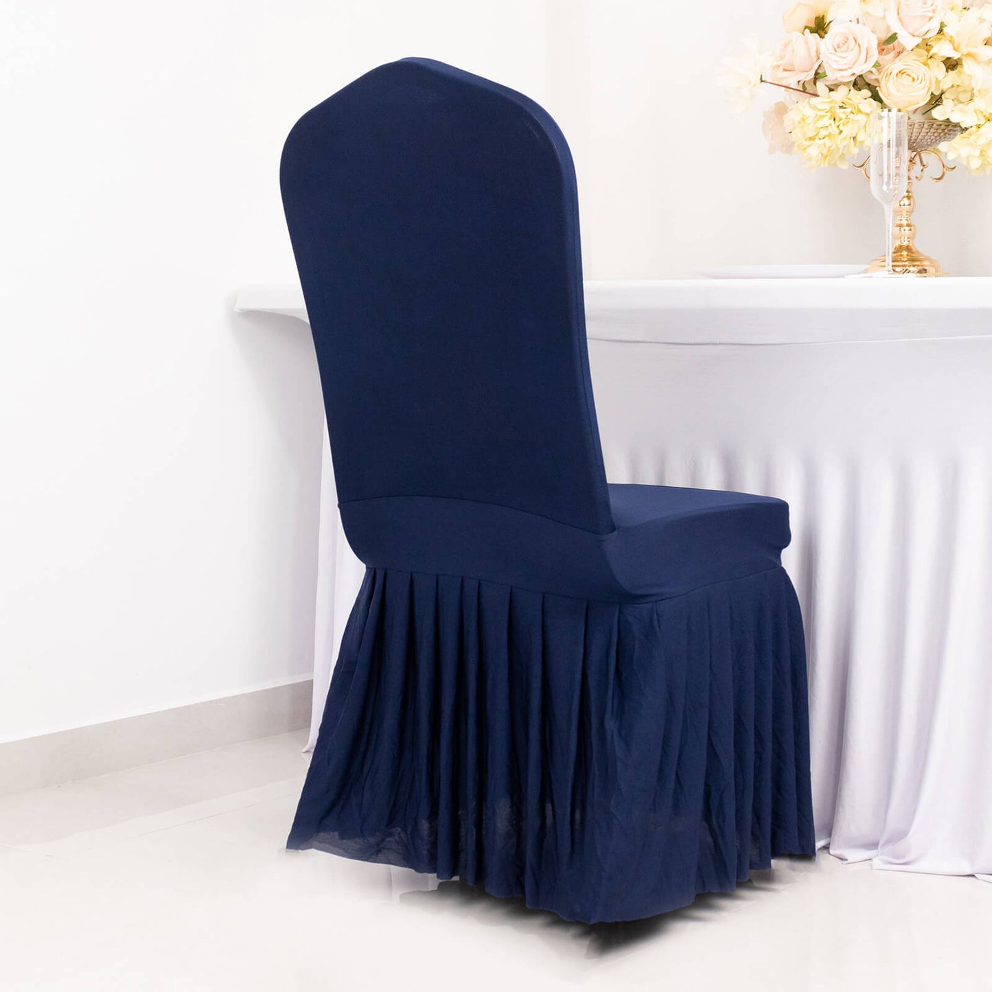 Navy ruffle pleated spandex chair slipcover on a banquet chair.