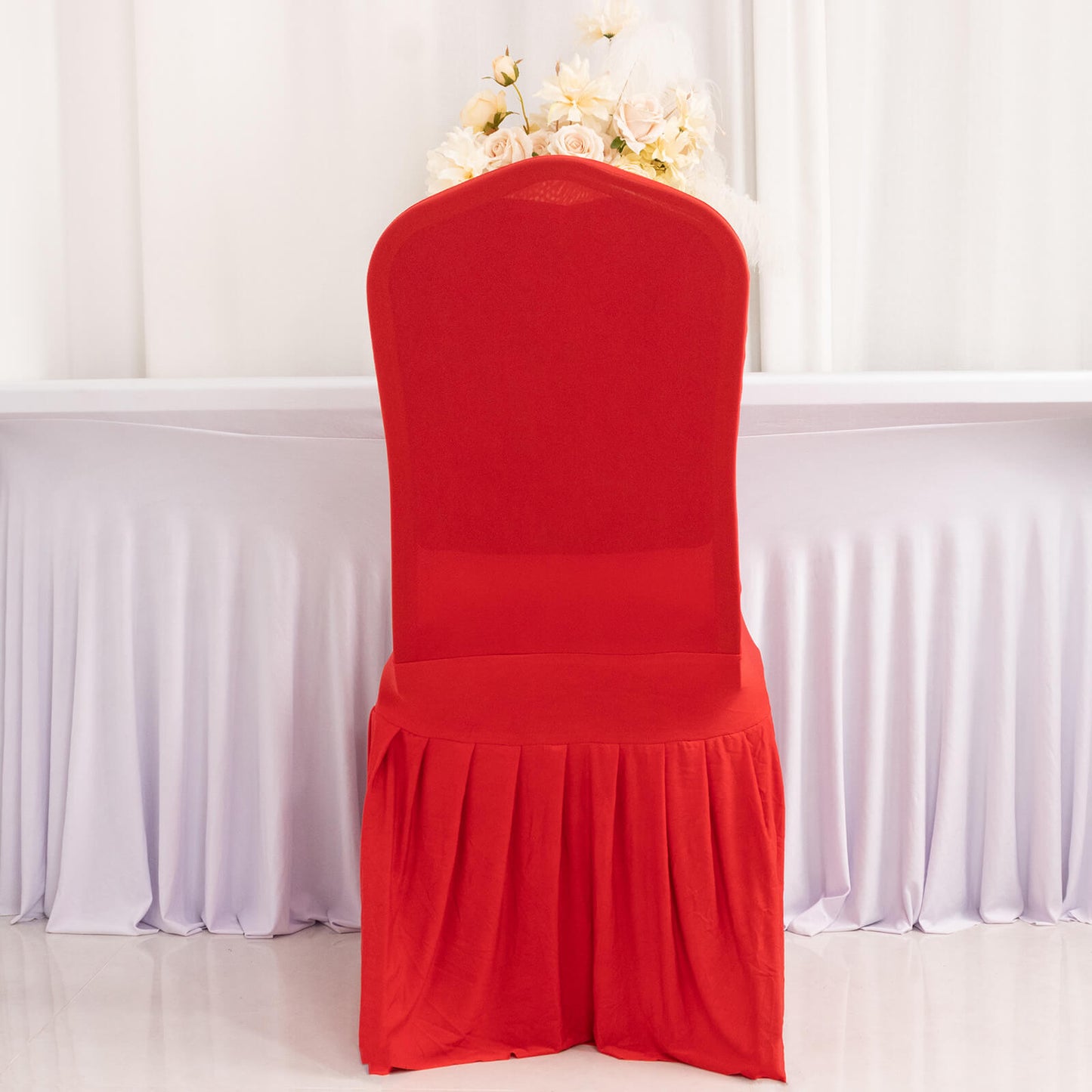 Red ruffle pleated chair slipcover for banquet settings.