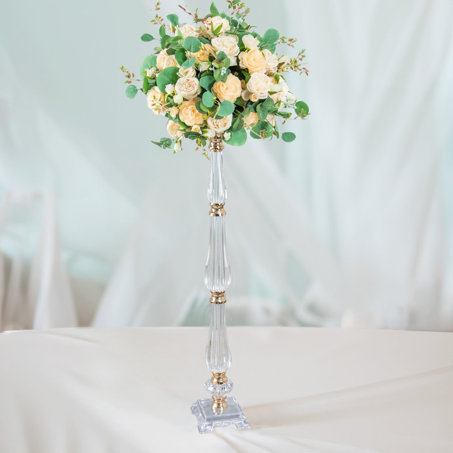 Gold acrylic crystal candle stand with floral arrangement centerpiece.