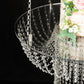 Clear acrylic chandelier wedding cake stand with hanging bead chains.
