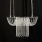 Clear acrylic crystal chandelier cake stand with bead chains. Perfect for weddings.
