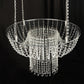 Clear acrylic crystal chandelier wedding cake stand with bead chains.