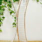 Gold metal frame hourglass vase with crystal pendant for floral arrangements.