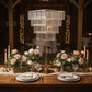 Gold crystal chandelier centerpiece with hanging crystals and floral arrangements.